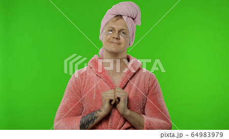 Portrait of transsexual man in bathrobe with eye patches. Chroma key Portrait of transsexual man in bathrobe with eye patches. Chroma key 64983979