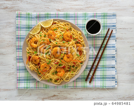 Prawn Schezwan Noodles with vegetables in a plate 64985481
