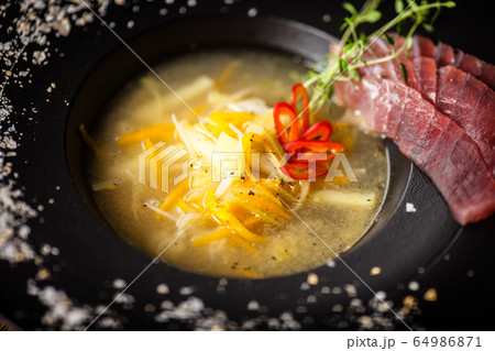 Clear Fish soup served in a bowl in restaurant Clear Fish soup served in a bowl in restaurant 64986871