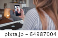 POV close-up young Caucasian woman talking to cheerful male friend on self isolation using smartphone video call online. 64987004