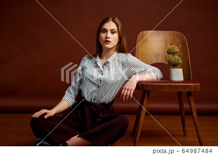 Gorgeous young female in classic suit, black shoes Gorgeous young female in classic suit, black shoes 64987484