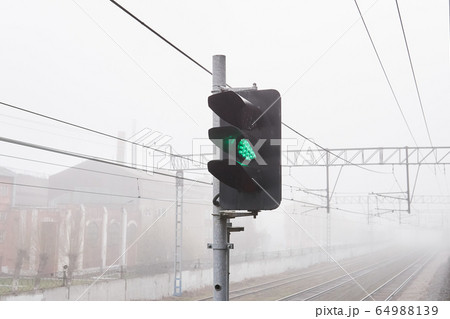 railroad rails lurking in fog, in the foreground 64988139