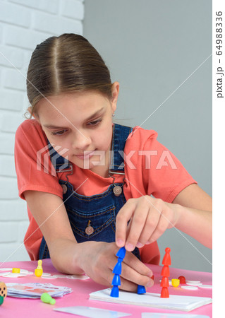 Girl enthusiastically puts chips on each other Girl enthusiastically puts chips on each other 64988336