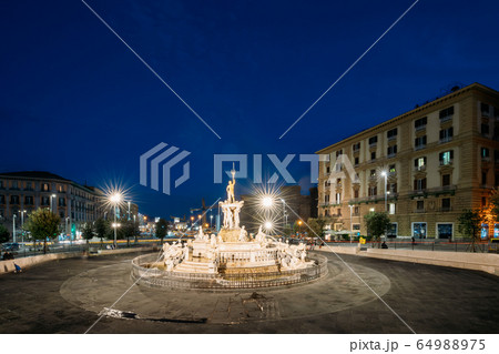 Naples, Italy. Fountain Of Neptune On Piazza Municipio In Evening Or Night Illuminations Naples, Italy. Fountain Of Neptune On Piazza Municipio In Evening Or Night Illuminations 64988975