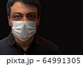 Man with mask on black background. Protection 64991305
