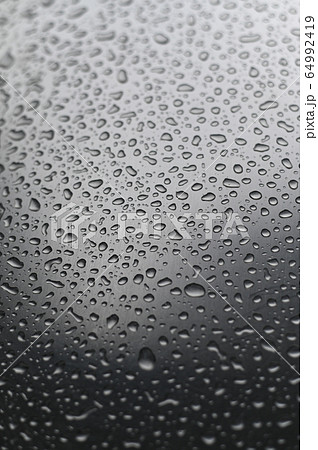 Water droplets on a stainless steel surface. 64992419