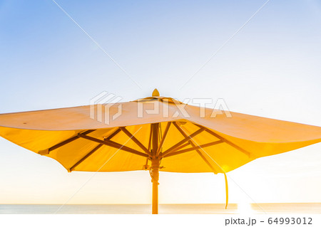 Beautiful tropical nature umbrella chair with palm tree around beach sea ocean at sunset or sunrise Beautiful tropical nature umbrella chair with palm tree around beach sea ocean at sunset or sunrise 64993012