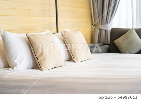 White comfortable pillow on bed decoration interior of bed room 64993613