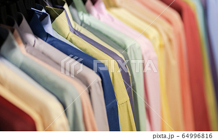 Close up of Multi colored shirts on hangers, 64996816