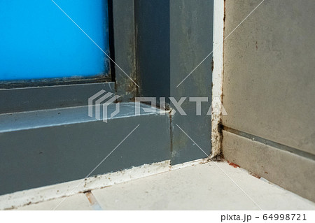 Old plastic window frame in the shower. Moldy 64998721