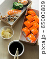 Beautiful rolls and sushi and california roll on a white table. Food delivery. Lunch. Food at home. 65000809