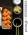 Beautiful rolls and sushi and california roll on dark table. Food delivery. Lunch. Food at home. 65000820