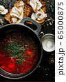 a traditional Ukrainian borsch made from beets, carrots, pork, potatoes, cabbage, herbs and garlic, close-up. 65000875