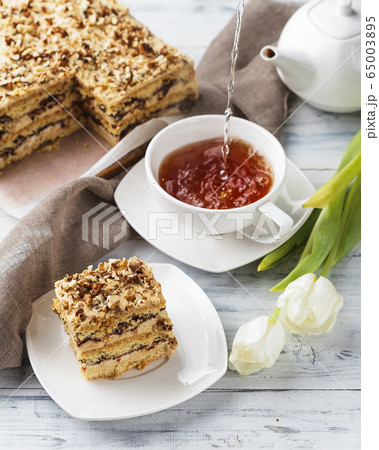 Pie with nuts on a white wooden background 65003895
