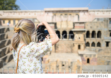 Young woman capture photo of Chand Baori Stepwell in Rajasthan India 65005142