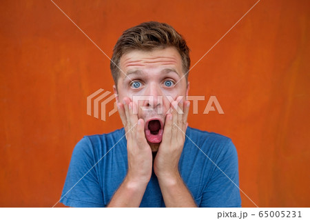 Handsome caucasian man is shocked with good news. 65005231