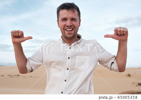 Self-satisfied and proud caucasian young man looks Self-satisfied and proud caucasian young man looks 65005358