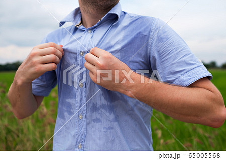 Man with hyperhidrosis sweating very badly under Man with hyperhidrosis sweating very badly under 65005568