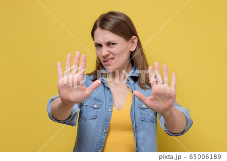 Young woman wearing casual clothes standing over 65006189