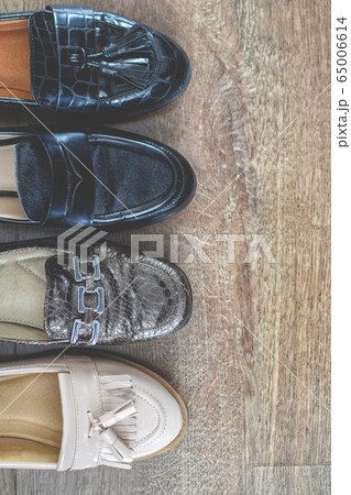 Loafers and other shoes retro style stand on the wooden floor. 65006614
