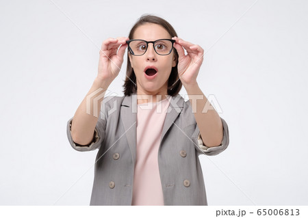Funny mature caucasian woman holding glasses and 65006813