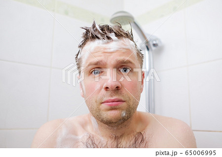 Worried caucasian foamed young man after the water Worried caucasian foamed young man after the water 65006995