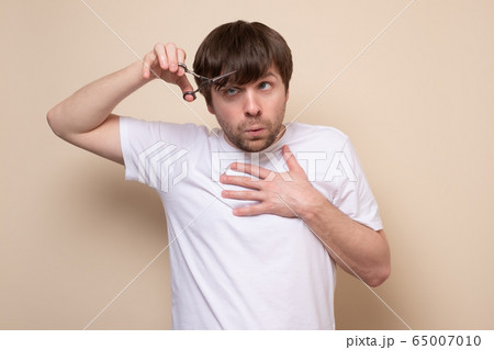 man trying to make a hairstyle by himself with man trying to make a hairstyle by himself with 65007010