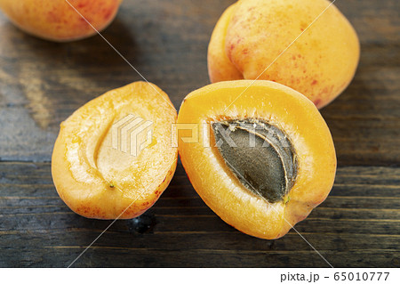 Ripe apricots on the wooden background. 65010777