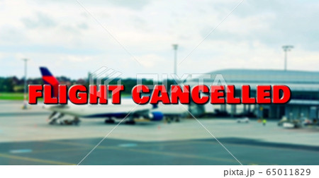 Cancelled flight at airport gate due to coronavirus. 65011829