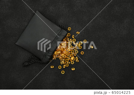Heap of golden rhinestone crystals in bag 65014225