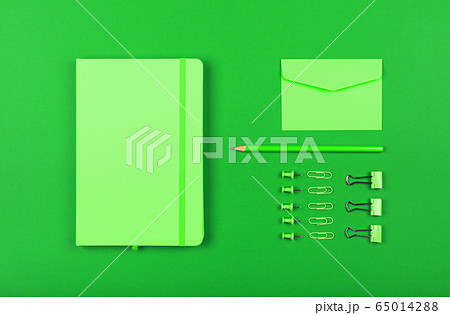 Neatly organized stationery flat lay of green 65014288