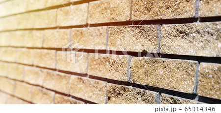Wall cladding. Decorative bricks with rocky relief surface. Wide-angle background with copy space Wall cladding. Decorative bricks with rocky relief surface. Wide-angle background with copy space 65014346