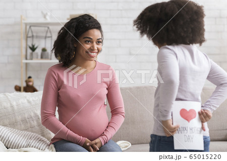 Little Kid Hiding Greeting Card For Pregnant Mom Behind The Back Little Kid Hiding Greeting Card For Pregnant Mom Behind The Back 65015220
