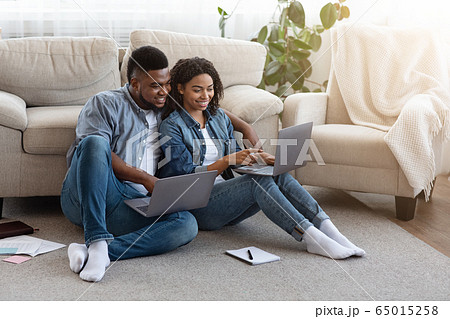 Remote Work. Black Couple Using Laptops At Home, Working Online Together Remote Work. Black Couple Using Laptops At Home, Working Online Together 65015258