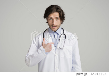 Puzzled male therapist pointing at himself with questionnaire face expression Puzzled male therapist pointing at himself with questionnaire face expression 65015596