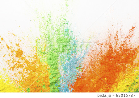 Beautiful multicolor powder explosion on white background Beautiful multicolor powder explosion on white background 65015737