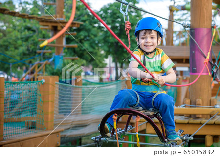 Little cute boy enjoying activity in a climbing Little cute boy enjoying activity in a climbing 65015832
