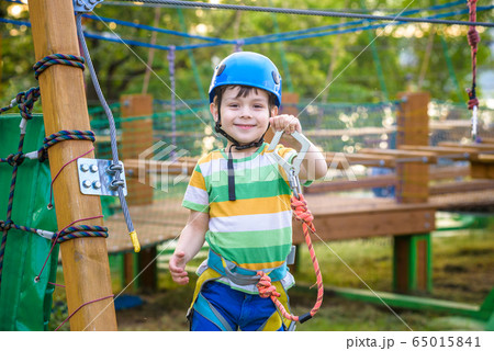 Little cute boy enjoying activity in a climbing 65015841