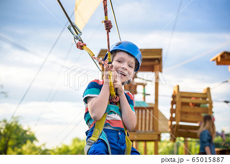Little cute boy enjoying activity in a climbing 65015887