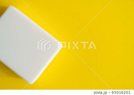 White soap on a yellow background. Hand hygiene. Washing hands is a best way to prevent coronavirus Covid-19 while global pandemic. White soap on a yellow background. Hand hygiene. Washing hands is a best way to prevent coronavirus Covid-19 while global pandemic. 65016201