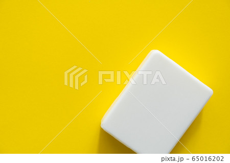 White soap on a yellow background. Hand hygiene. Washing hands is a best way to prevent coronavirus Covid-19 while global pandemic. White soap on a yellow background. Hand hygiene. Washing hands is a best way to prevent coronavirus Covid-19 while global pandemic. 65016202