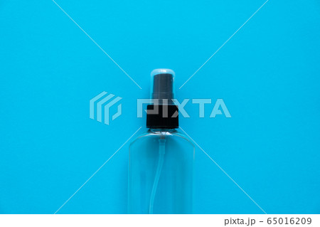 Bottle of antiseptic, a bottle of hand sanitizer, hand sanitizer spray on a blue background, for the prevention of coronavirus. Bottle of antiseptic spray mockup, copy space for design. Bottle of antiseptic, a bottle of hand sanitizer, hand sanitizer spray on a blue background, for the prevention of coronavirus. Bottle of antiseptic spray mockup, copy space for design. 65016209