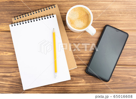 Notebook with pencil, smartphone, and coffee cup. Notebook with pencil, smartphone, and coffee cup. 65016608