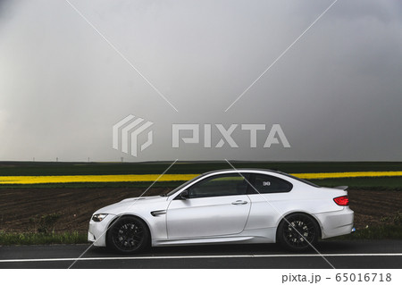 White luxury sedan on the highway in the fog White luxury sedan on the highway in the fog 65016718