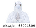 medic man wearing protective clothing against the virus is pray  65021309