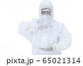Doctor with protective clothing presenting blank palm of her hand 65021314