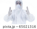 Doctor with protective clothing presenting blank palm of her hand 65021316