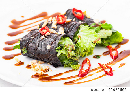 Raw vegan nori hand rolls with sauce, salad and Raw vegan nori hand rolls with sauce, salad and 65022665