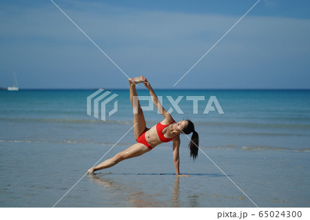 Asian Chinese Woman in various yoga poses at the 65024300