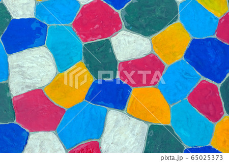 The walkway in the garden are paved with brightly colored stones and have just been cleaned by washing with water. 65025373